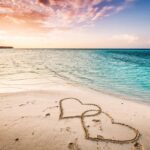 two-hearts-drawn-on-a-sandy-beach-by-the-sea